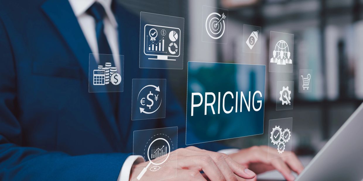 Businessman working on pricing strategy with financial icons.
