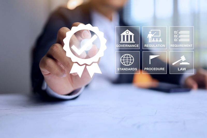 Businessman tick checkmark on certification approved that means has been certified to a quality standard or has passed on standards requirement audit according to industry regulation compliance