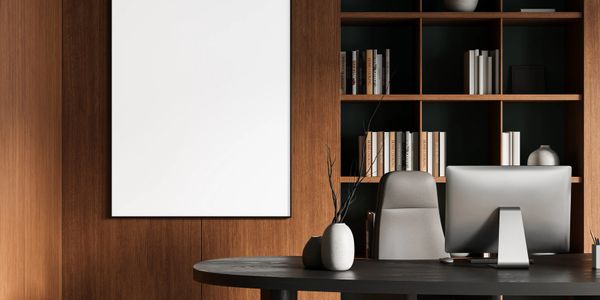 Modern office with wooden shelves, black desk, and blank wall art.