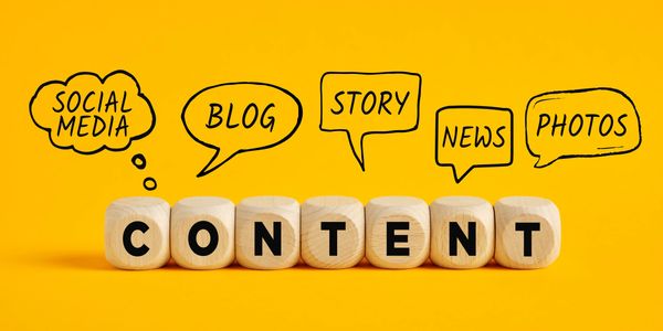 Wooden blocks spelling CONTENT with social media terms above.