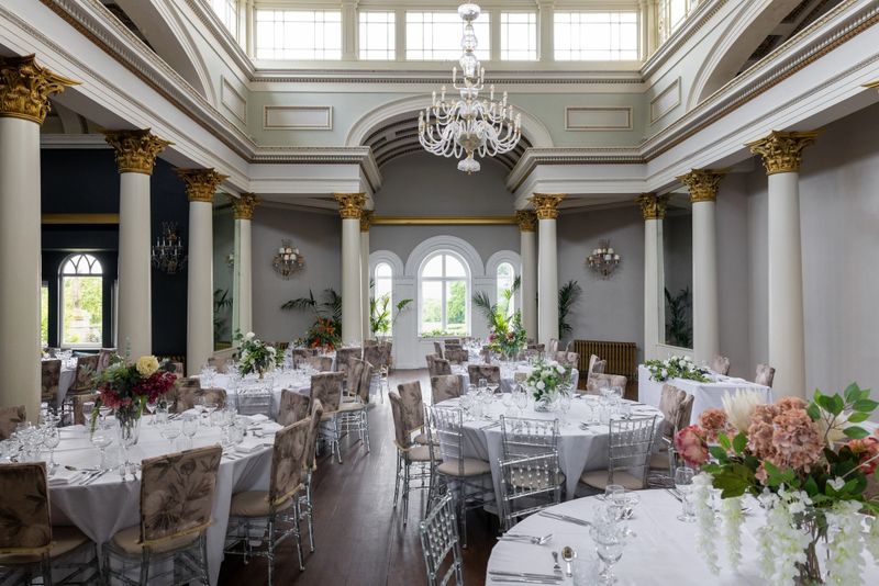 A grand and luxurious banquet hall set for a formal event, featuring round tables adorned with white linens, floral centerpieces, and fine glassware. Classical columns with gold detailing, high arched windows, and a stunning chandelier add to the room’s opulent ambiance. Perfect for weddings, upscale receptions, or gala events, this image captures timeless elegance and refined celebration in a beautifully lit, sophisticated setting.

Videos are available similar to this scenario.