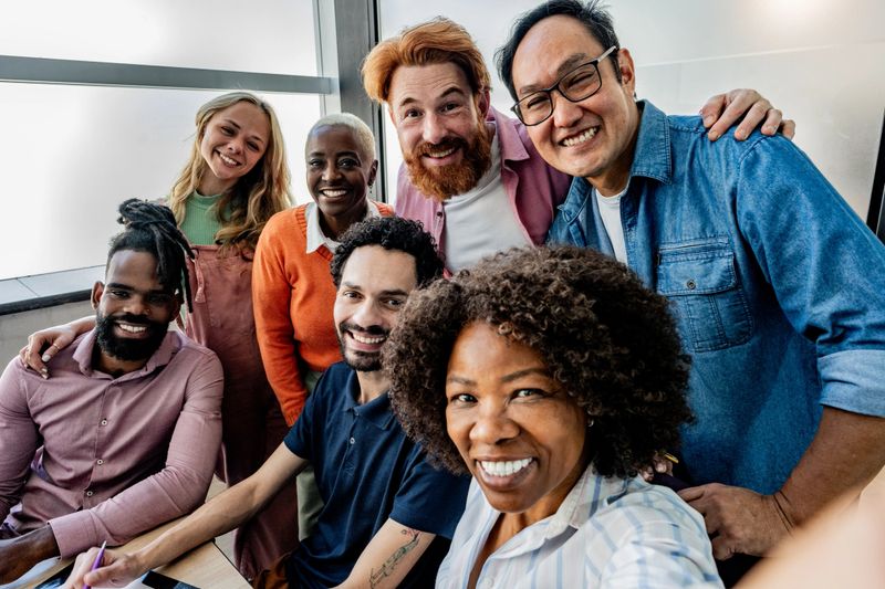 Coworkers taking a selfie at office - Camera point of view