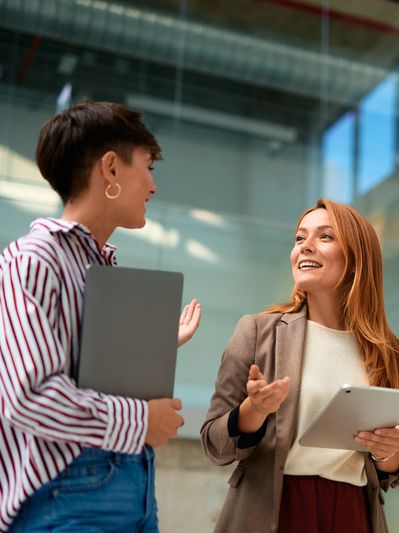 Two women having a discussion in a modern office