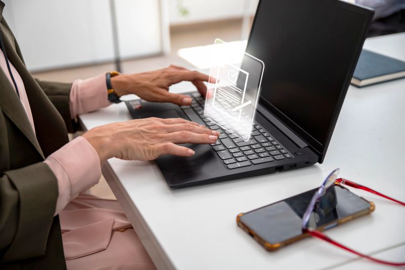 Woman using laptop working on Electronic document management in virtual notebook screen, online document database and digital file storage systems