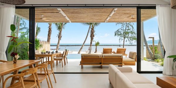 Open living space with ocean view and wooden furniture.