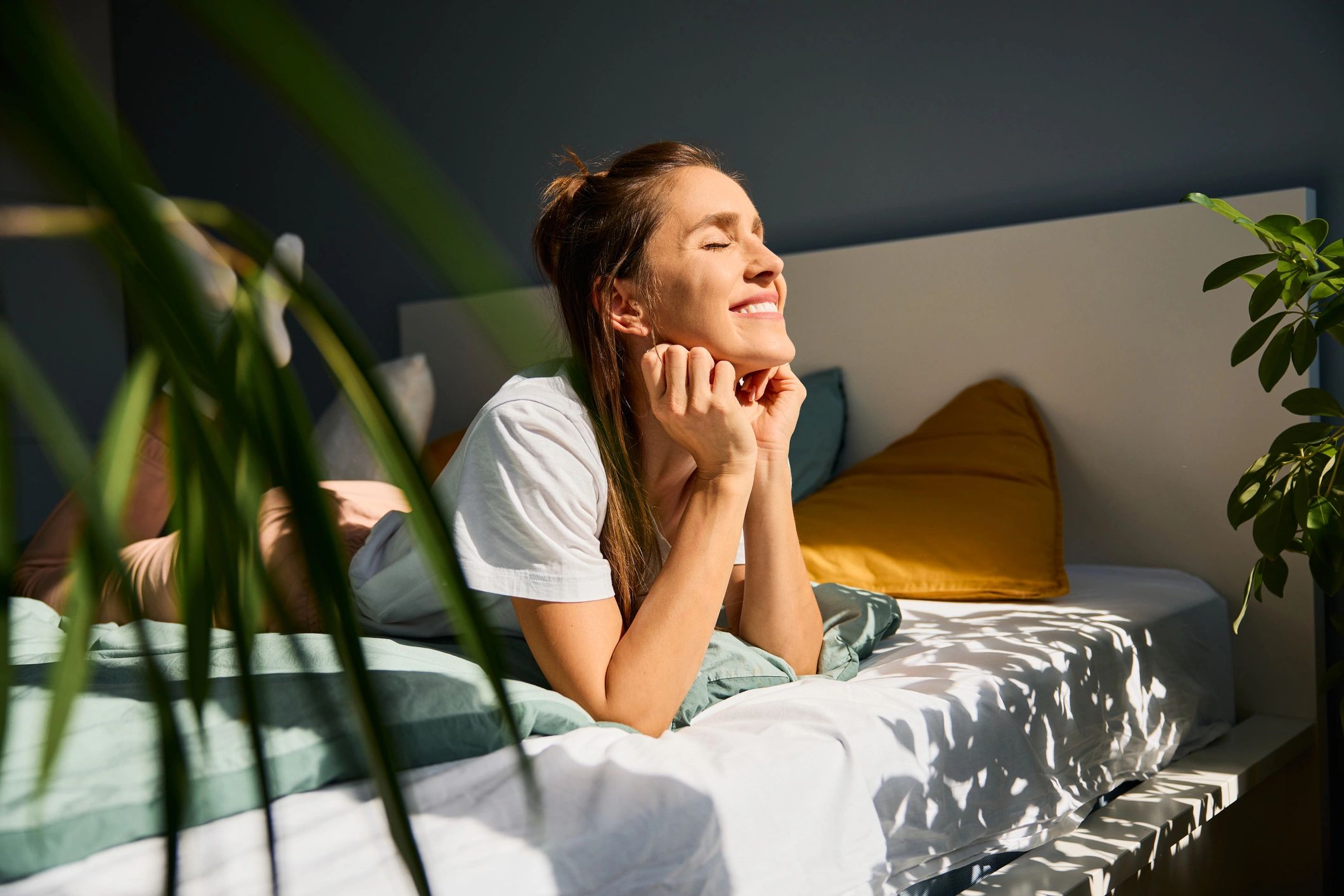 Person resting in morning light, representing sleep hypnotherapy and deeper rest
