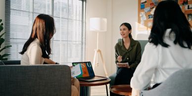 Three women having a meeting in a modern office.