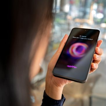 Person holding smartphone with AI assistant on screen.