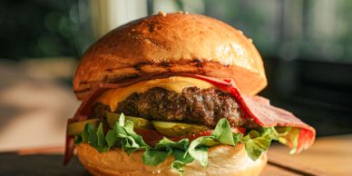 Juicy cheeseburger with lettuce and tomato.