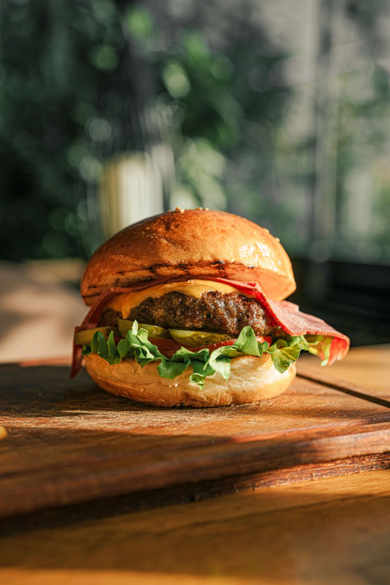 Delicious Hamburger on Wooden Table – Stock Photo