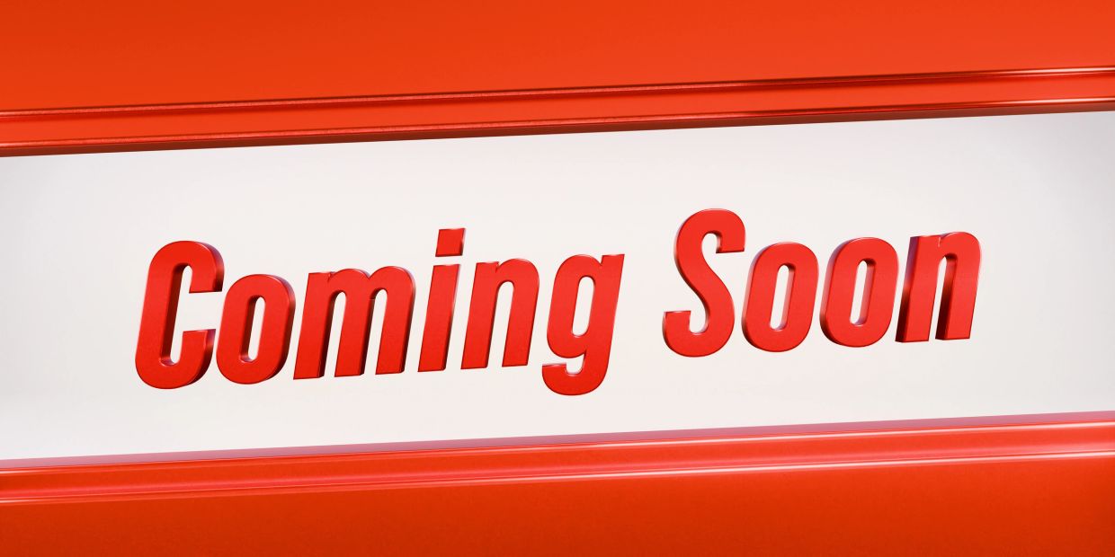 Red 3D text "Coming Soon" on a white background framed by red borders.