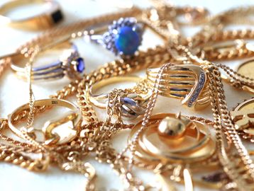 Close-up of gold and silver rings with chains.