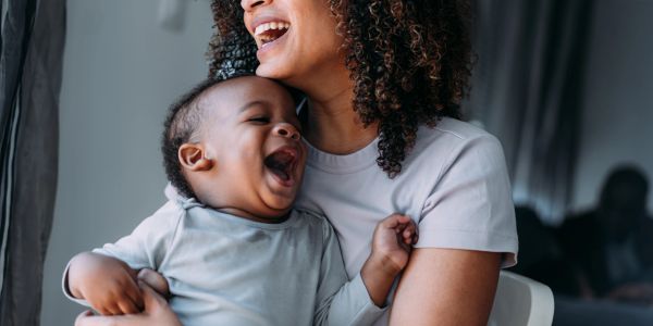 Mother and baby laughing joyfully.