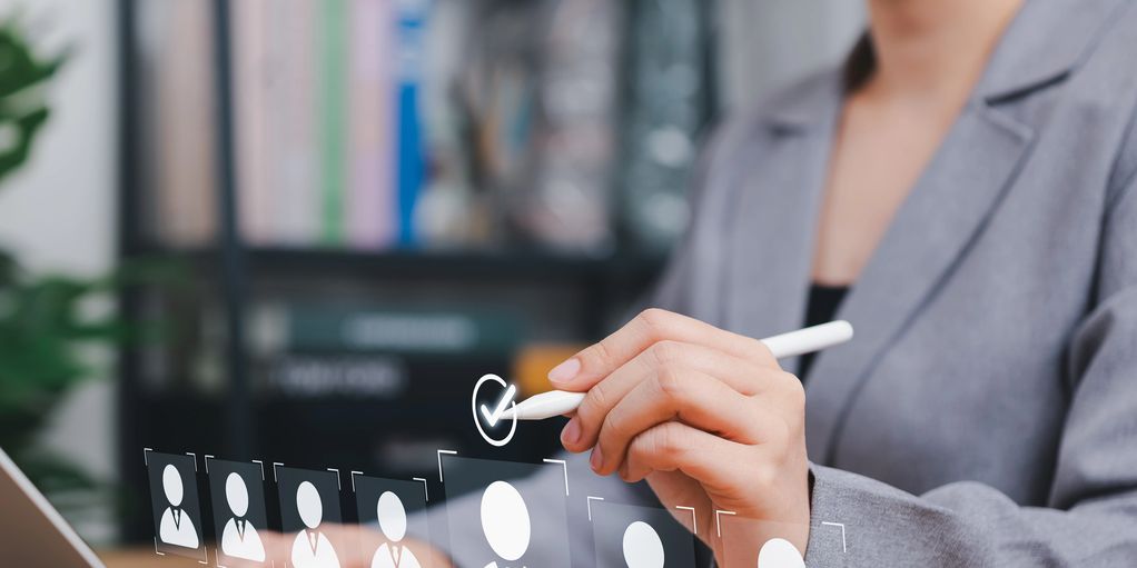 Person selecting profile on a virtual interface.