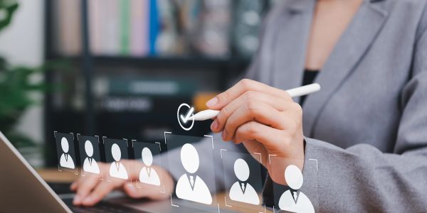 Person selecting a candidate on a virtual recruitment interface.