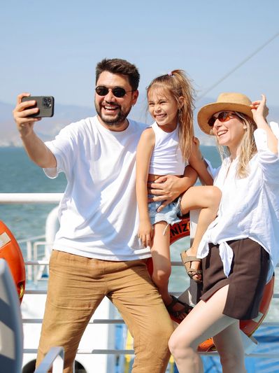 Family takes a selfie on a boat.