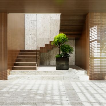 Modern interior with stairs and potted plants.