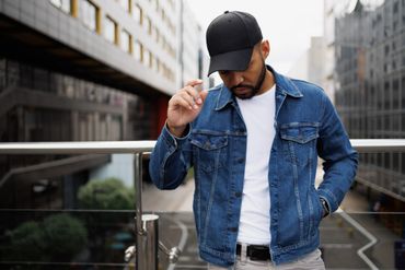 Edgy black cap with studs and embossed designs.