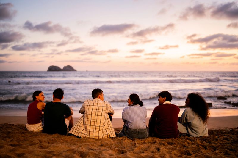 Young friends talking on the beach