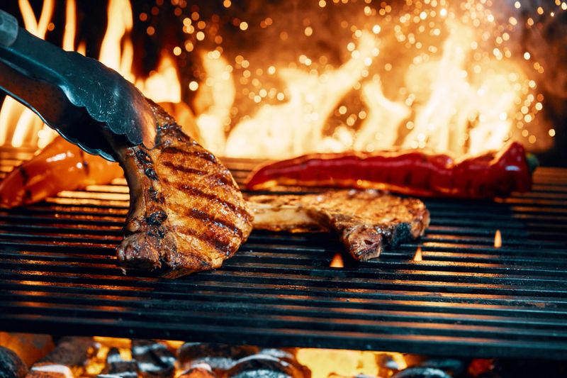Pork Chops on BBQ Grill with Open Flames