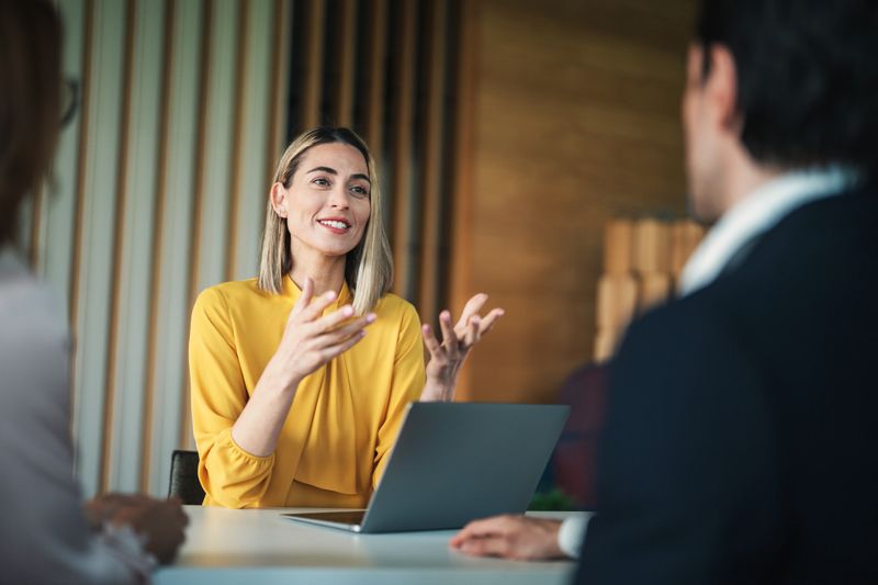 Colleges sharing ideas and important documents during a meeting in the office.