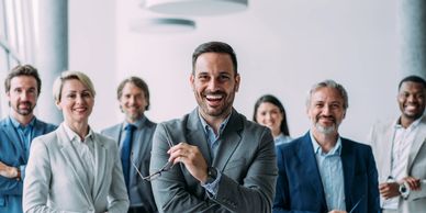 Group of happy professionals posing in office.