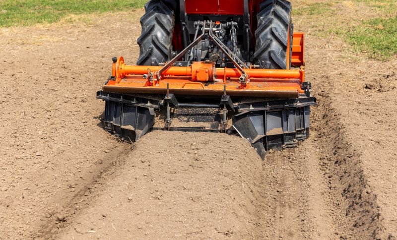 Farm tractor with agriculture soil bed former ridger.