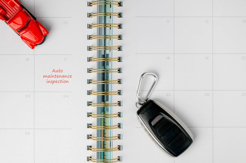 Auto maintenance inspection concept with red truck and key on calendar.  Reminder for service, repair or warranty visit.