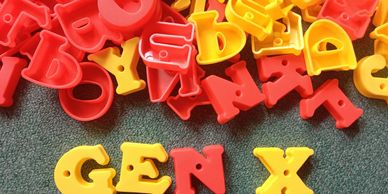 Yellow and red plastic letters with 'GEN X' spelled out at the bottom.