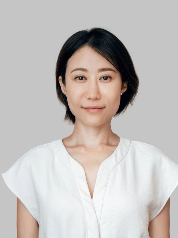 Portrait of a woman with short black hair and white blouse.