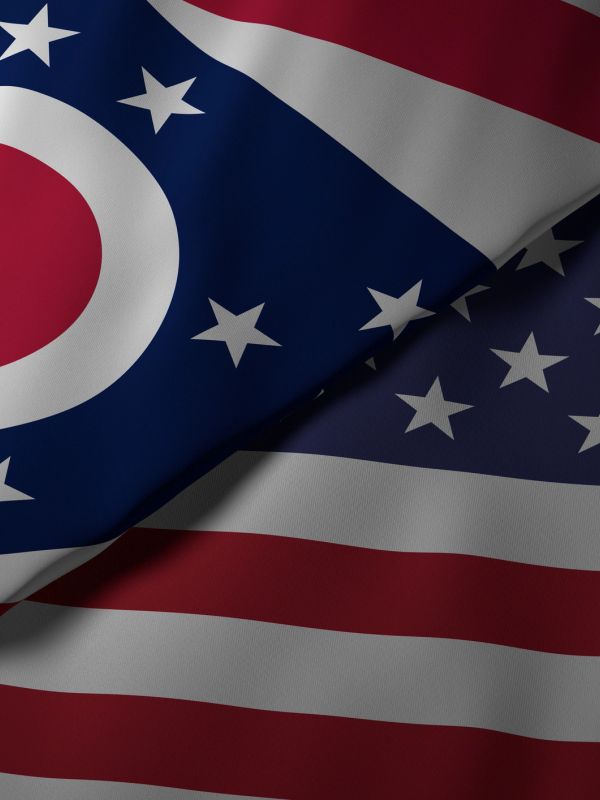 Close-up of folded Ohio and United States flags showing stars and stripes.
