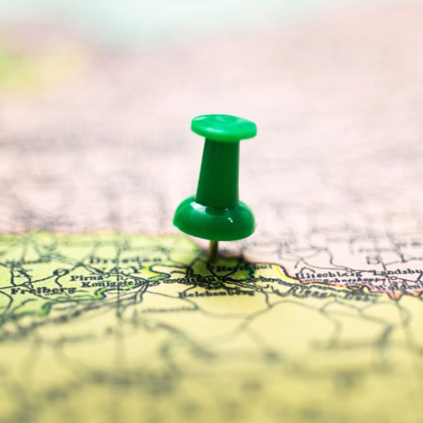 Green pushpin marking a location on a map.