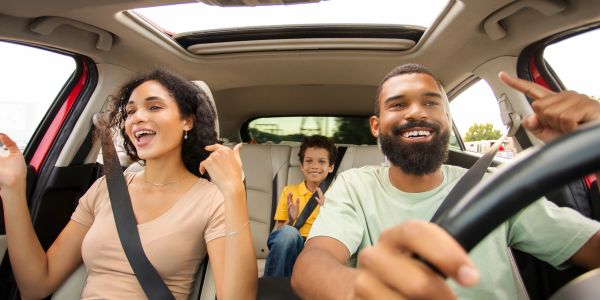 Family enjoying a car ride together.