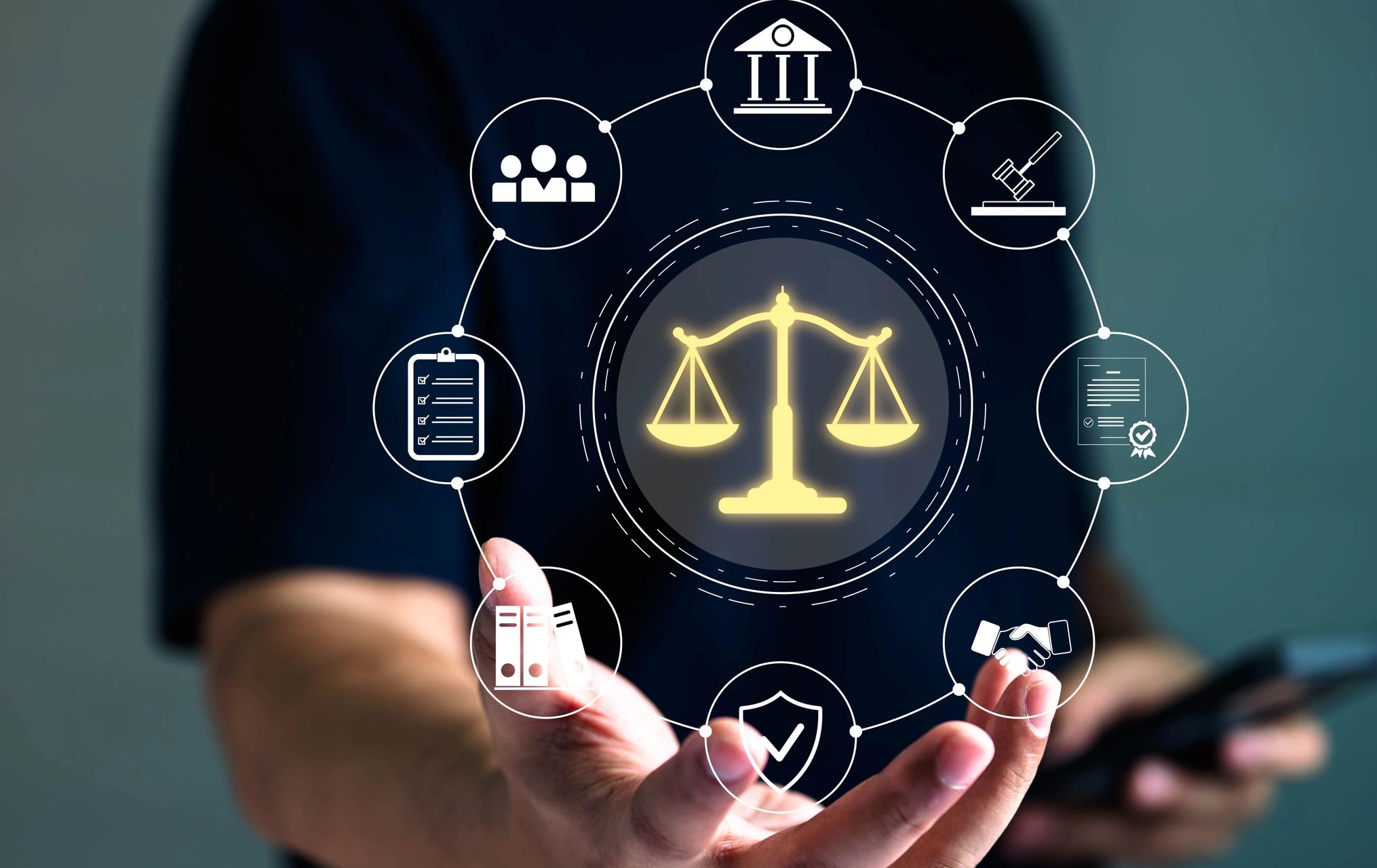 Hand holding legal icons with scales of justice highlighted.