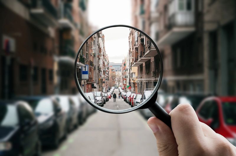 A magnifying glass focusing on a city street in Madrid, Spain.