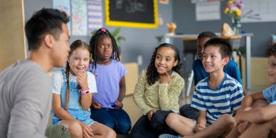 Teacher engaging with young students in a classroom circle.