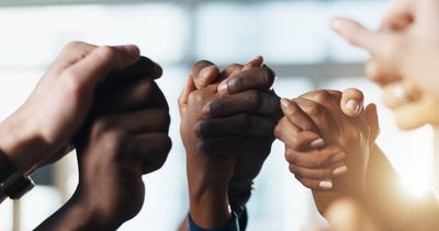 Diverse hands joined together in solidarity and unity.