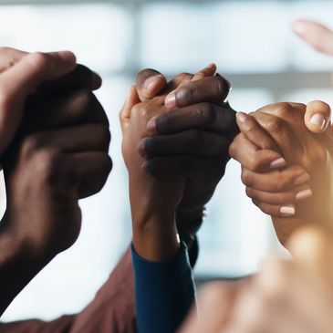 People holding hands in unity.