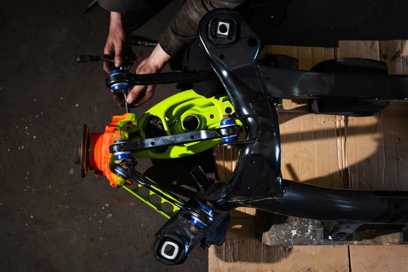 Rear Suspension and Hub Assembly Installation. Building drift car rear suspension with fresh bushings, vibrant arms, and restored hub.