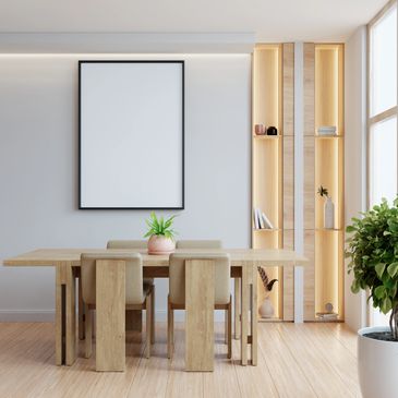 Minimalist dining room with wooden table, beige chairs, and built-in illuminated shelves.