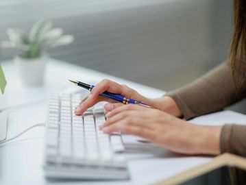 Virtual assistant typing on a keyboard 