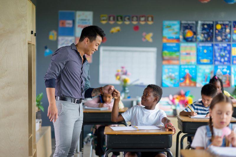 An engaging classroom scene showing a teacher interacting with diverse students during a lesson, fostering collaboration and learning through a supportive and inclusive environment.