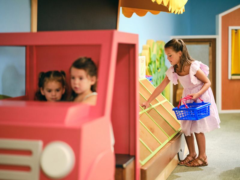 Children playing in an indoor playground in a children’s museum.