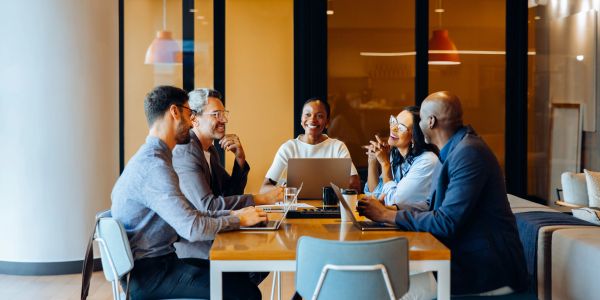 Group discussion around a table in a modern office.