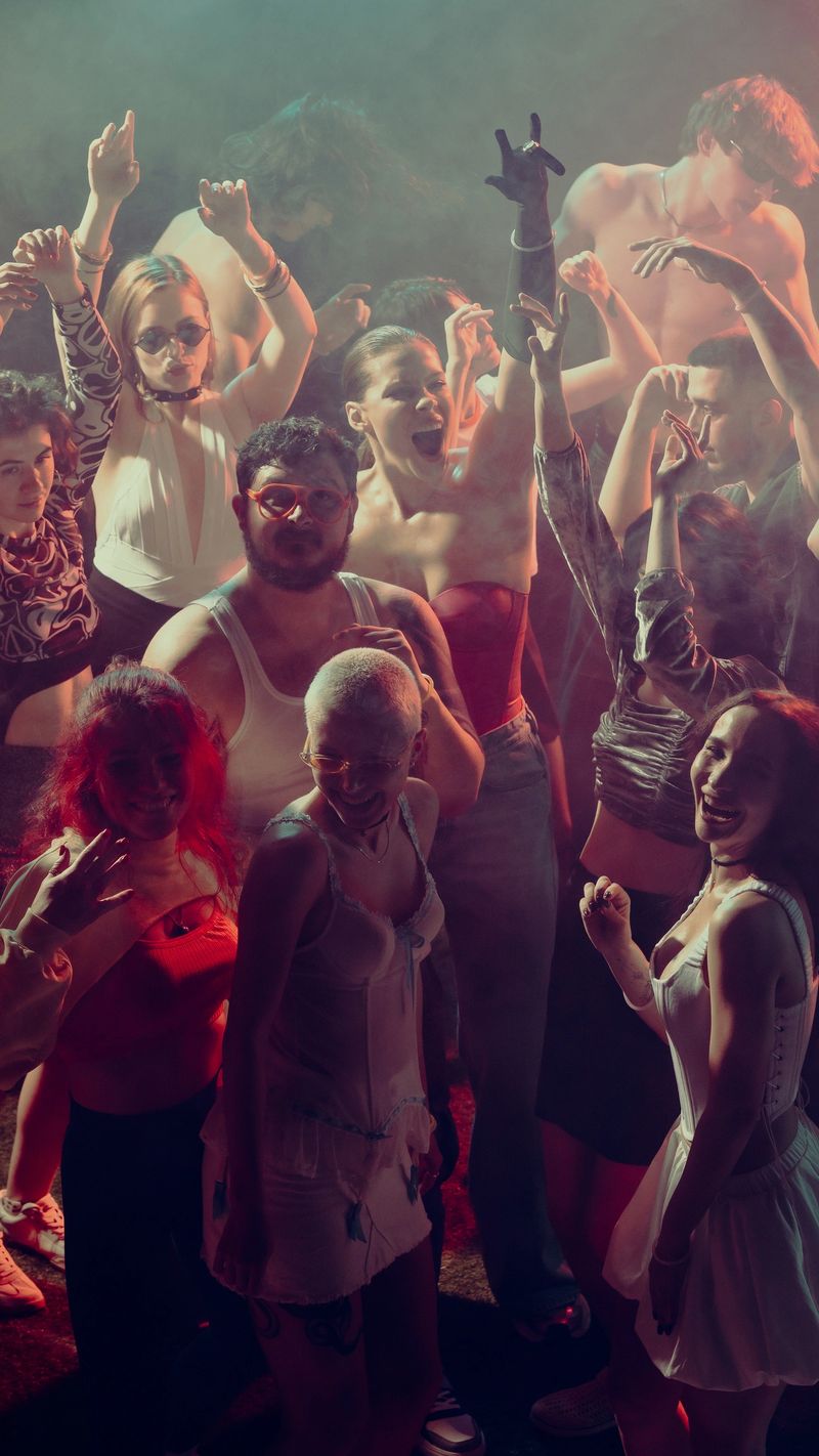 A lively party scene with diverse people dancing and enjoying a vibrant atmosphere. Concept of nightlife party, youth, summer, festivity, celebration