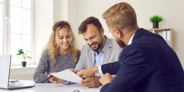 Couple discussing papers with a professional.