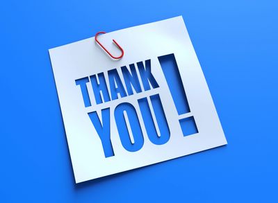 A paper note with "THANK YOU!" cut out and clipped with a red paperclip.