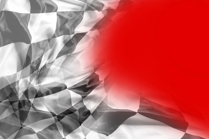 Checkered black and white flag on red background. Copy space