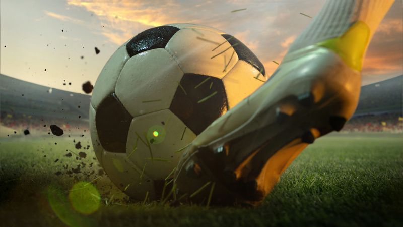 Close-up of a footballer's boot kicking a ball during a 3D-rendered scene on a stadium grass field at sunset. Concept of leadership, decision-making, and vision in captain roles and midfield control