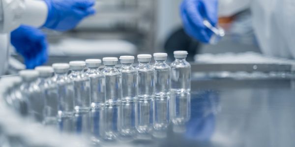 Vials filled with liquid in a sterile environment.